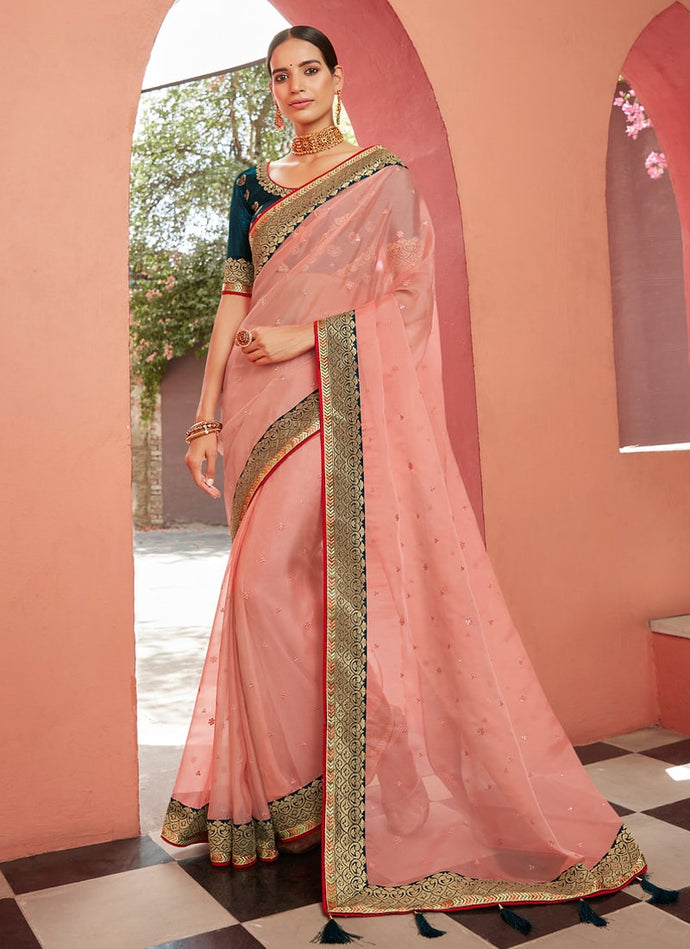 Festive wear light peach colored organza based saree