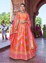 Load image into Gallery viewer, stunning orange colored traditional wear embroidered silk base lehenga choli
