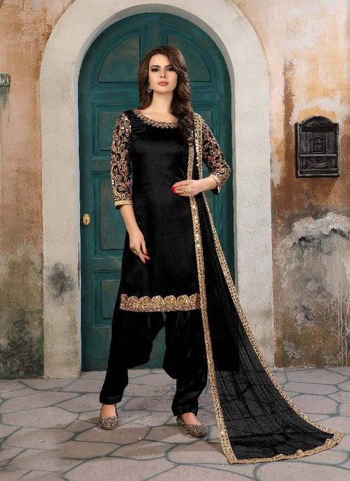 black colored elegant look velvet base Patiala suit with bordered laced dupatta