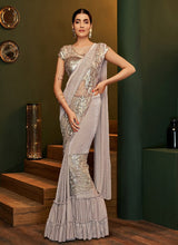 Load image into Gallery viewer, Glitzy beige colored partywear silk base designer saree
