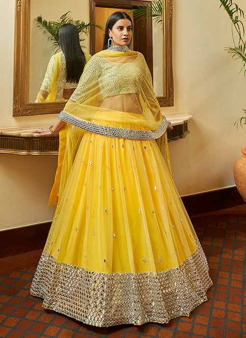 Ravishing Soft net base Yellow color Lehenga Choli with Mirror and Zari work